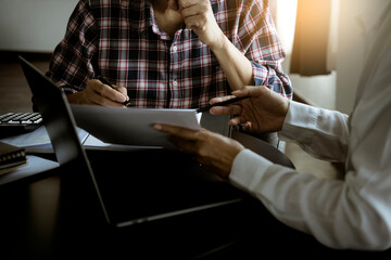 Poster - Businessman and woman holding papers over laptop