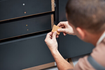 Sticker - Handyman making kitchen wall cabinets in the apartment.