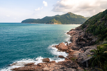 Wall Mural - wild place, stone shore, top view, turquoise sea waves at sunset