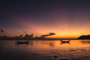 Wall Mural - silhouettes of fishing boats on the sea at a beautiful sunset