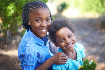 Wall Mural - Hes an excellent big brother. Cute african american siblings spending time together in nature.