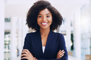 Poster - I am proud of how far I have come. Cropped portrait of an attractive young businesswoman smiling and standing in the office with her arms crossed during the day.