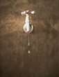 Conserve every drop you can. Cropped closeup shot of a tap dripping water.