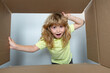 © Volodymyr - Amazed adorable little boy peeking inside gift box, unpacking present with funny astonished expression, impatient child unboxing surprise. Kid opening package.