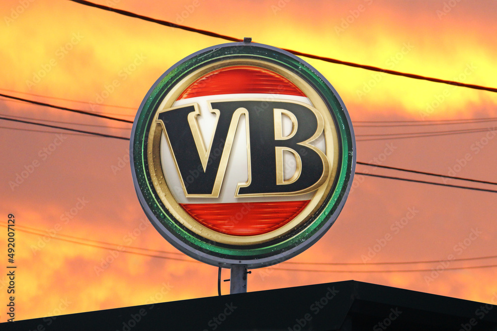 Retro spherical illuminated sign for a Victoria Bitter beer brand above ...