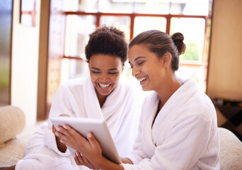 Aufkleber - Checking in At the spa. Shot of two friends in bathrobes using a digital tablet at a spa.
