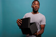 © DC Studio - Cheerful guy feeling surprised after unpacking gift box and opening to see delivery order. Shocked man unboxing package present from postal delivery service, enjoying shopping surprise.