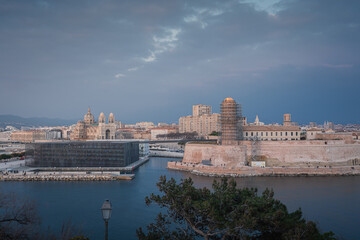 Wall Mural - Sunset and night view over Cathedral, Fort and Mucem buildings in Marseille harbour, France