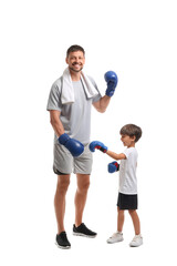 Poster - Little boy with and his boxing trainer on white background