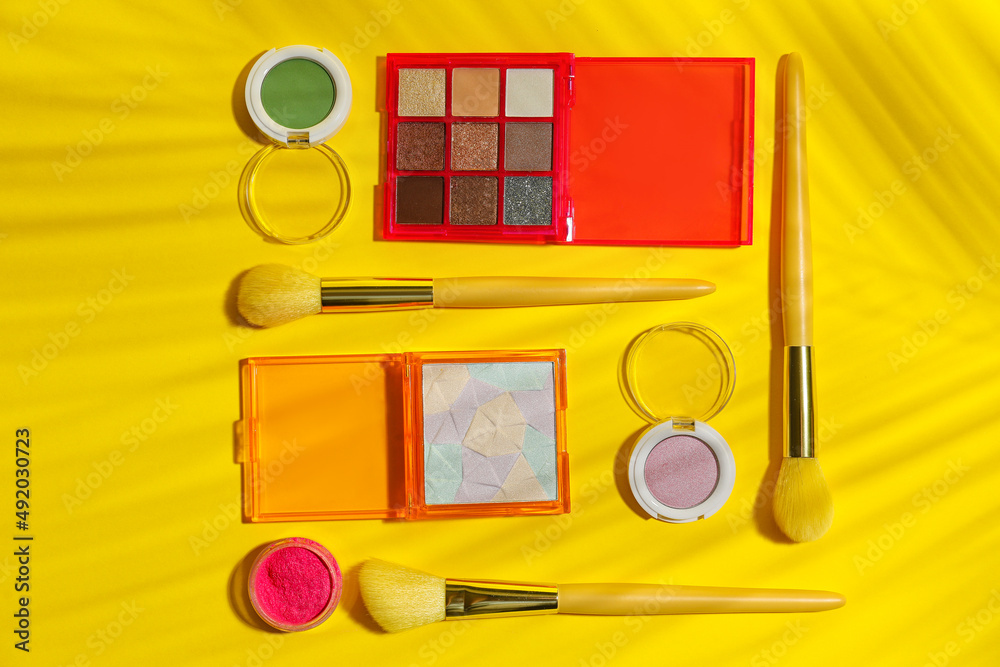 Makeup products on yellow background