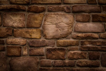 Old Odd Shaped Tan And Brown Thick Cut Stone Block Wall