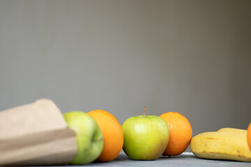 Wall Mural - fruits on a table against a gray background with space for text