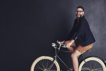 Poster - I ride my bike wherever I like. Portrait of a trendy young man riding a bicycle in studio.