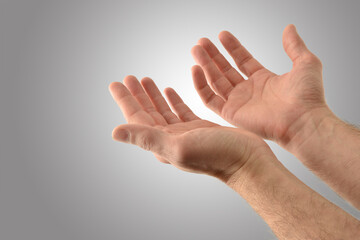 Wall Mural - Hands up with asking gesture with gray isolated background