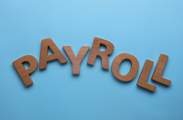 Wall Mural - Word Payroll made with wooden letters on light blue background, flat lay