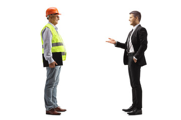 Wall Mural - Young businessman talking to a mature engineer