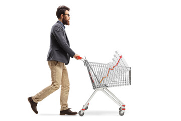 Wall Mural - Full length profile shot of a bearded man pushing a shopping cart with a bar chart diagram inside