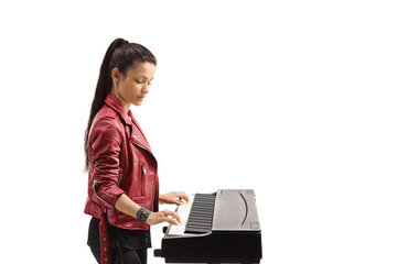 Profile shot of a young woman playing a digital piano