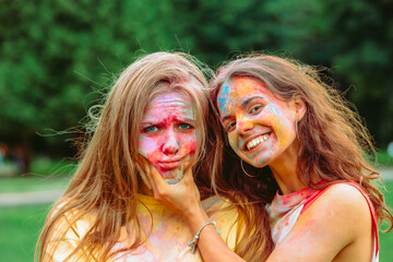 Canvas Print - two women girlfriends having fun at holi fest