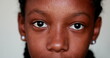 Young black girl close-up eyes staring at camera