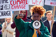 © Monkey Business - Group Of Protestors With Placards And Megaphone On Demonstration March Against Climate Change