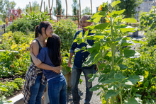 Sisters Hugging In Sunny, Urban Community Garden