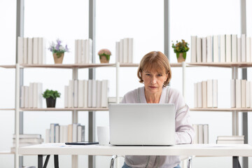 Wall Mural - senior woman using laptop computer and serious at work