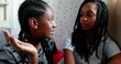 © Marco - Candid black teenager girlfriends chatting in conversation. Casual real people