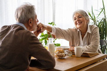 Wall Mural - Elderly couple in love. Senior husband and wife hugging and bonding with true emotions