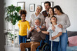 Multi generation, multiethnic family at home together, grandfather with disability