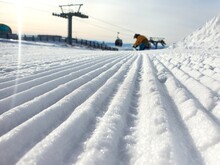 Prepared Ski Trail. Panoramic Point Of View The Skier's Feet On The Descent Start From A Straight Line, Rows Of Freshly Prepared Well-groomed Ski Slopes