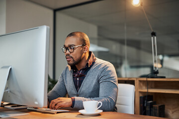 Sticker - Focus on your goals and achieve them. Shot of a focused young businessman working in his office.