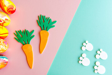 Easter decoration on green and pink background, easter eggs concept and rabbit footprint.