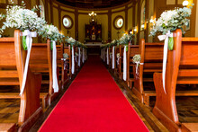 Wedding Decoration On The Church Benches With Red Carpet Church Walkway