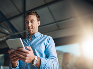 Fototapete - Business on the move. Cropped shot of a handsome young designer using his digital tablet in the office.