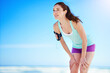 © Thurstan H/peopleimages.com - Taking a breather. Shot of a young woman working out on the beach.