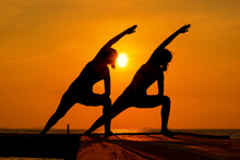 Silhouette Cople Woman Yoga.Silhouette Yogini Sport Woman Pose Practice Yoga Exercise On Sand Beach , Yoga Is Meditation Heathy Sport Concept.