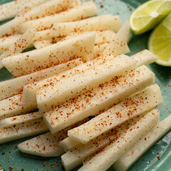 Wall Mural - Mexican yam bean also called Jicama with chili powder