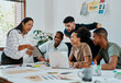 © Nicholas Felix/peopleimages.com - This is what the competition is looking like. Shot of a group of young businesspeople using a digital tablet during a meeting in a modern office.
