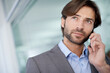 © Mikolette M/peopleimages.com - Contacting his clients. A handsome young businessman communicating via cellphone.