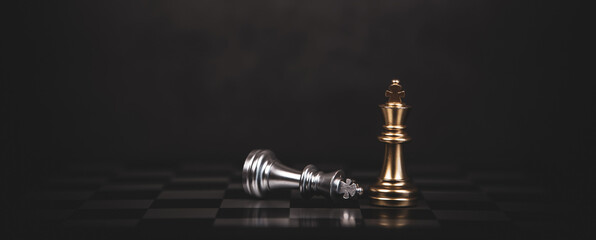 Close up king chess stand with falling chess on the back concept of team player or business team and leadership strategy and human resources organization management.