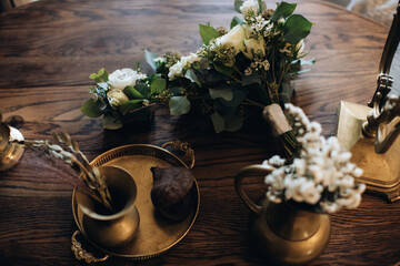 Poster - Beautiful wedding bouquets and bronze utensils on a wooden table. Wedding accessories