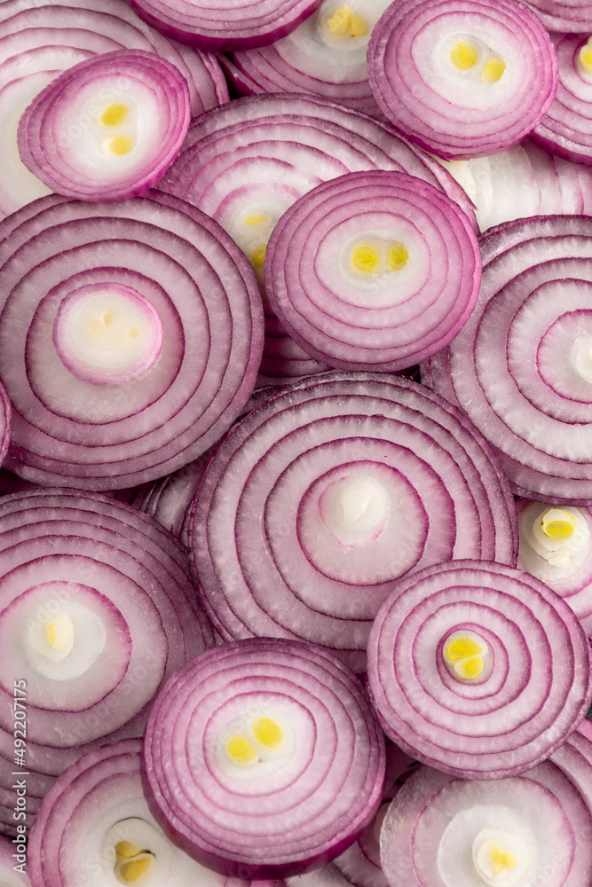 Purple onion circles background. Organic food ingredients