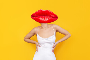 A young woman headed by huge red lips in a white elegant dress keeping her hands on the waist isolated on color yellow background. Trendy collage in magazine style. Contemporary art. Modern design