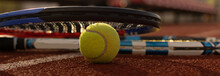 A Tennis Racket And New Tennis Ball On A Freshly Painted Tennis Court
