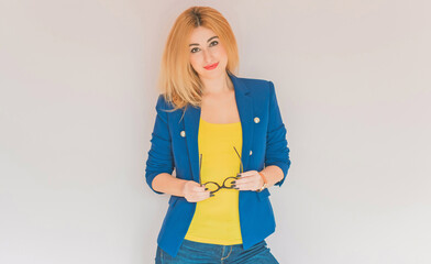 Business style for ladies, women in blue jacket and yellow top, fashionable concept