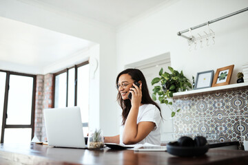 Poster - Shes been fortunate to find many opportunities as a freelancer. Shot of a young woman talking on a cellphone while working on a laptop at home.