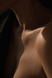 Bare neck, shoulders and collarbones of a beautiful woman. Beauty and details of the female body. Youth concept.