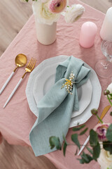 Canvas Print - ranniculus flowers, pink linen tablecloth and green napkins