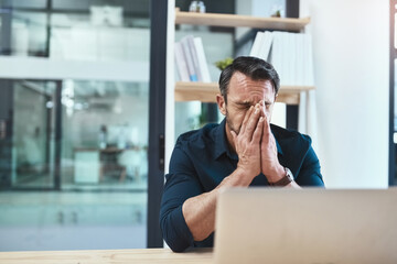 Canvas Print - I hope I didnt lose that client. Shot of a mature businessman looking stressed out at his desk.